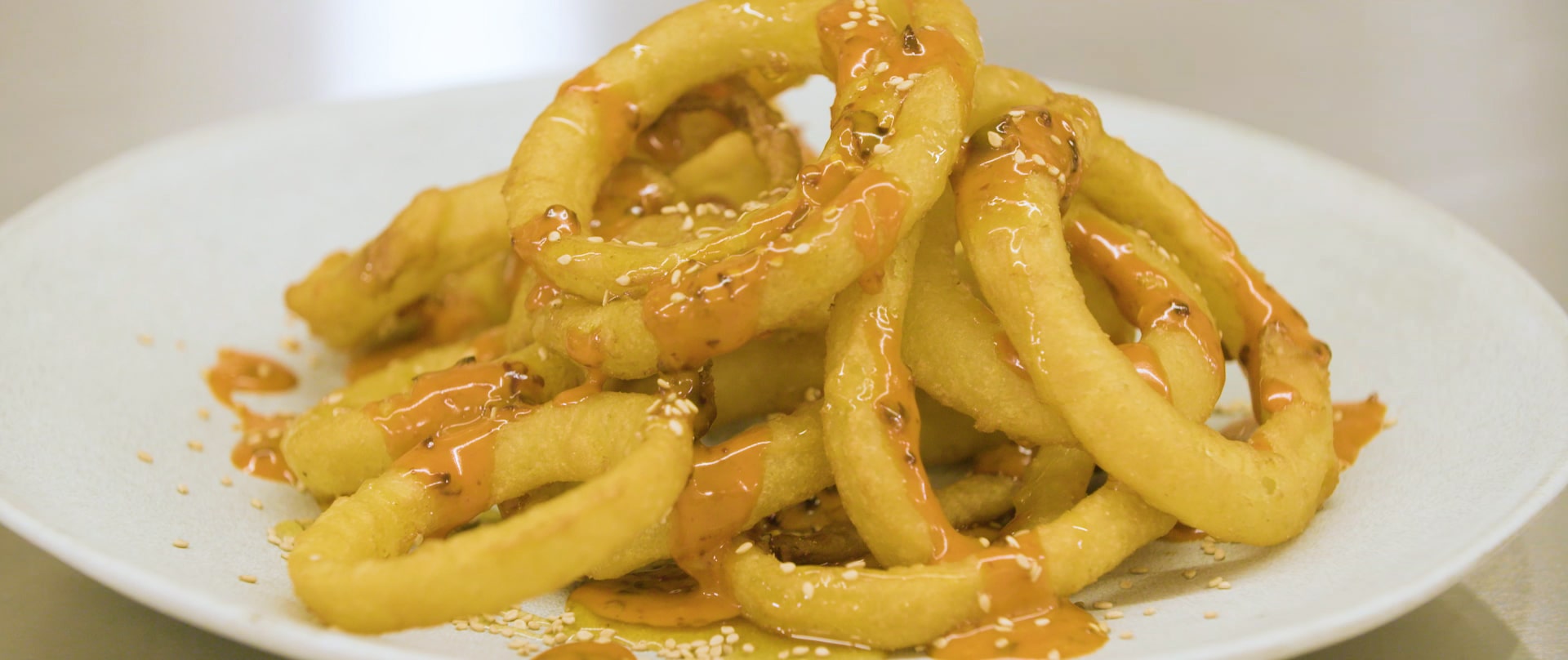 Hot Honey-Sesame Glazed Beer Battered Onion Rings with Amazon Sauce